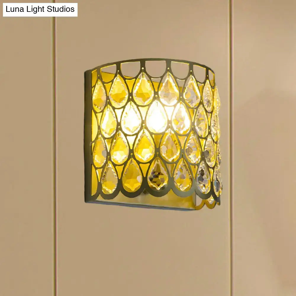 Minimalist white wall lamp with warm curved frame and clear crystal teardrop accents for bedroom lighting