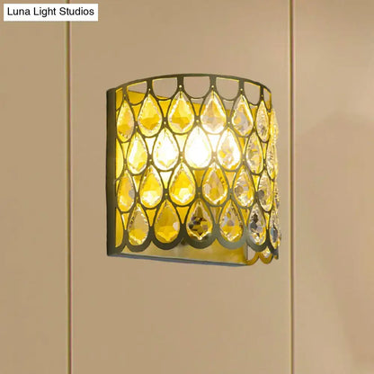 Minimalist white wall lamp with warm curved frame and clear crystal teardrop accents for bedroom lighting
