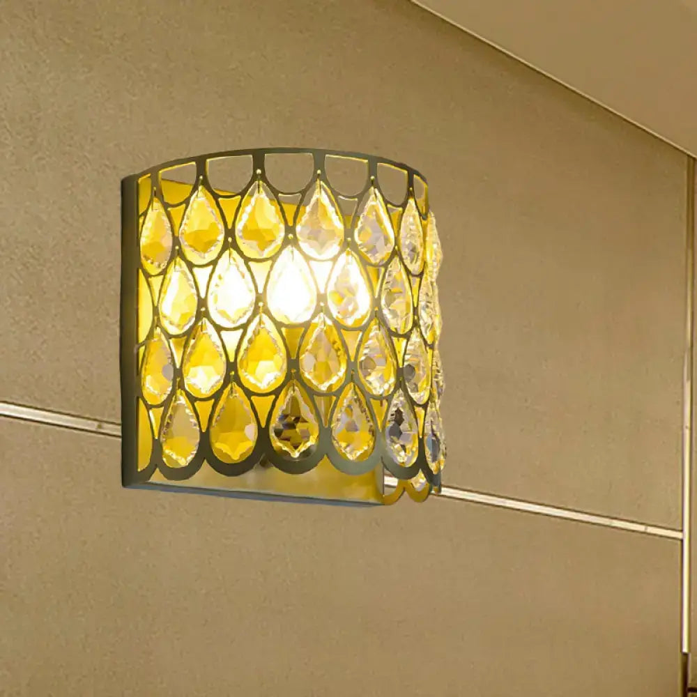 Minimalist white wall lamp featuring a warm golden-yellow clear crystal teardrop pendant with a black metal frame