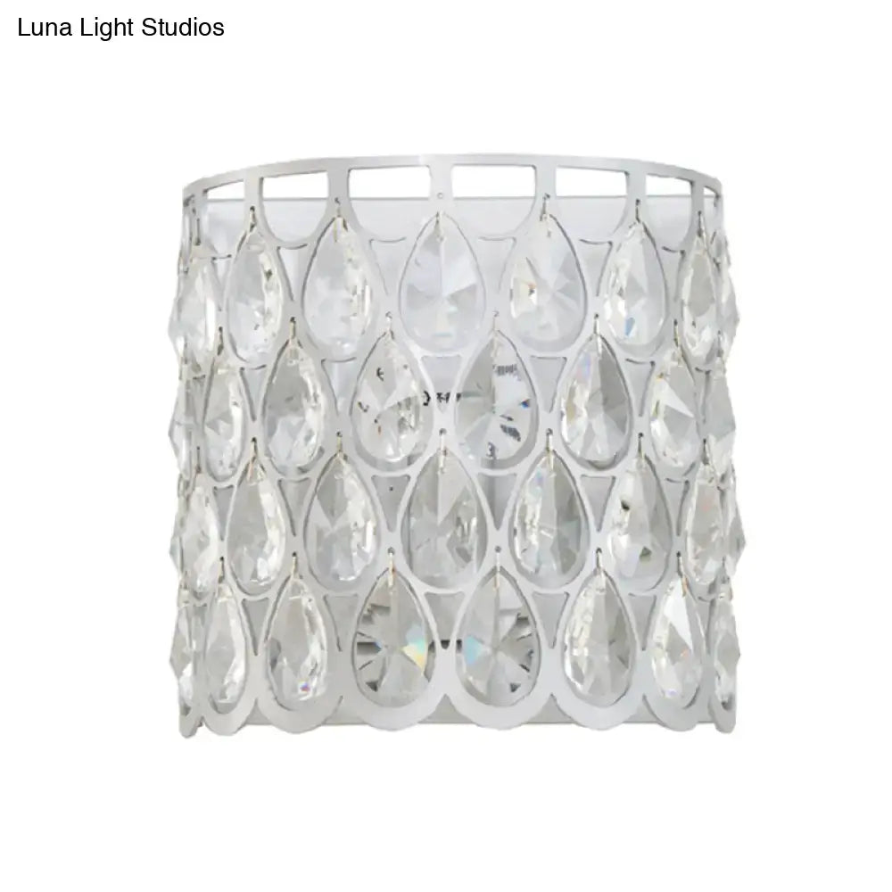 Minimalist white wall lamp featuring a clear crystal teardrop pendant with a silver-toned metal frame for bedrooms