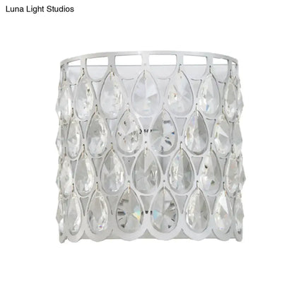 Minimalist white wall lamp featuring a clear crystal teardrop pendant with a silver-toned metal frame for bedrooms
