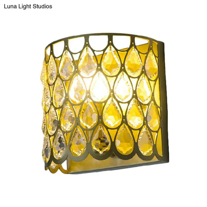 Minimalist white wall lamp featuring a golden clear crystal teardrop pendant with a sleek curved metal frame