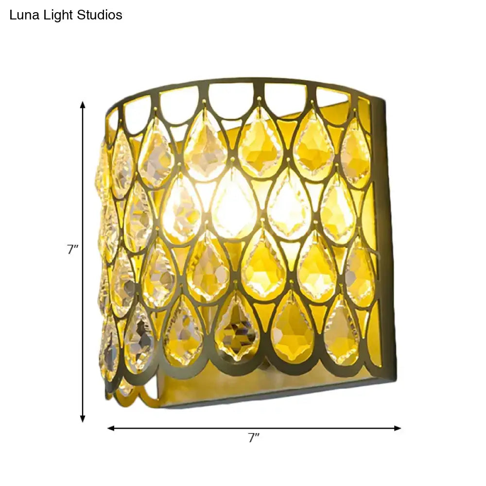 Gold-toned wall lamp with cascading faceted clear crystal teardrop amber crystals ideal for bedroom lighting