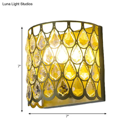 Gold-toned wall lamp with cascading faceted clear crystal teardrop amber crystals ideal for bedroom lighting