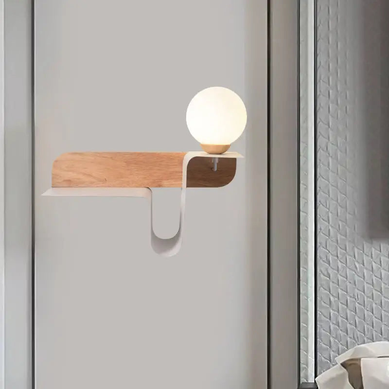 Minimalist white wall lamp with matte white spherical led bulb and frosted glass shelf mounted on wooden base for bedroom