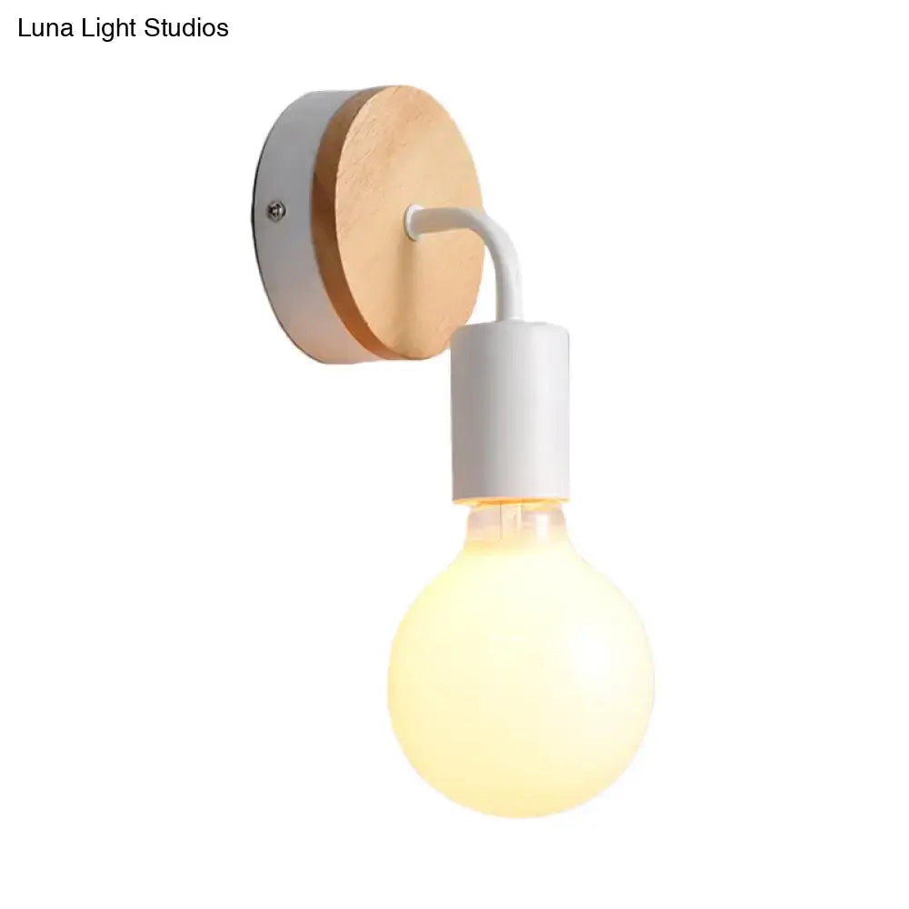 Minimalist white and wood wall sconce with circular wooden backplate and direct wired electric illumination for bedroom use