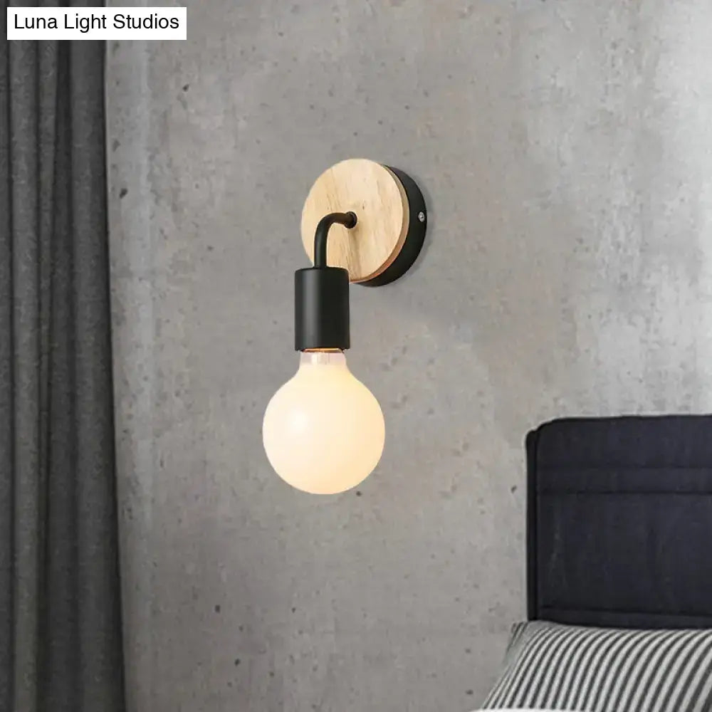 Minimalist white and wood wall sconce with round wooden backplate black metal arm and direct wired electric light fixture