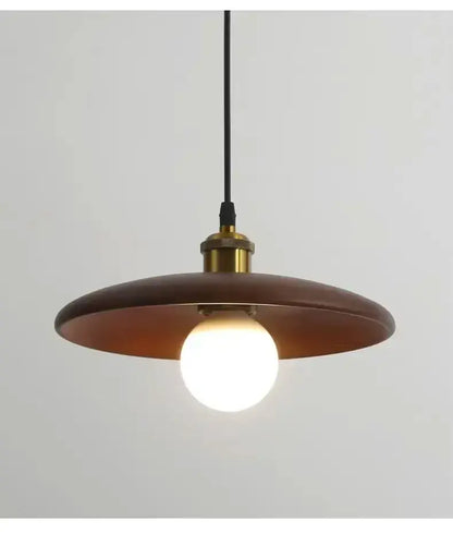A warm-toned circular wooden pendant light with brass fixture and led bulb featuring three-color dimming for dining rooms