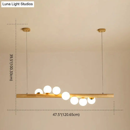 Minimalist wood and glass linear island pendant with warm wooden bar and spherical glass bulbs for kitchen lighting