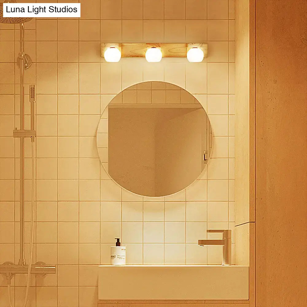 Round minimalist mirror with thin metallic frame above white glass sink in wood and white glass 2 light led vanity sconce 220v-240v