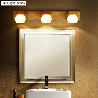 Minimalist warm-toned wooden vanity light fixture with three white glass led bulbs for 220v-240v use