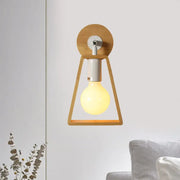 Minimalist warm-toned wall lamp with natural wood trapezoid frame and circular backplate for bedroom sconce