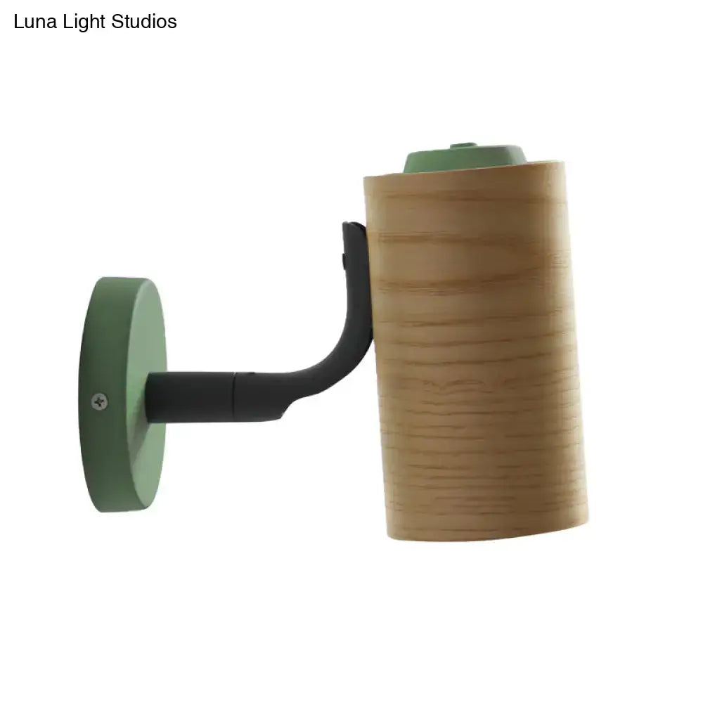 Minimalist wall light fixture with light wood cylindrical shade and green metal base for bathroom use