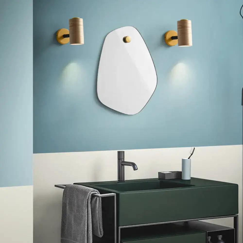 Modern white irregular mirror with gold fixture and cylindrical wooden sconces minimalist wall light fixture