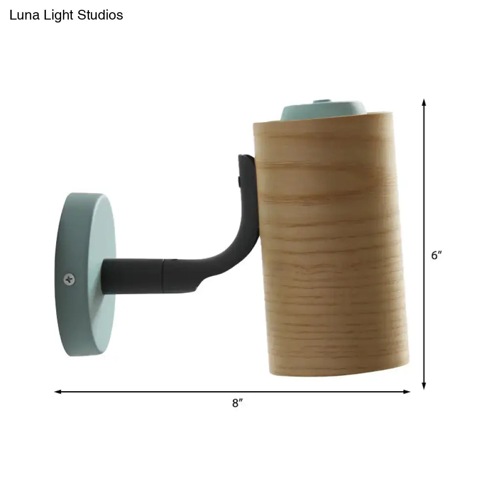 Minimalist wood wall light fixture with cylindrical wooden shade, black metal arm, and light blue accents for bathroom use
