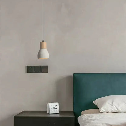Minimalist pendant lamp with white ceramic shade and light wood top suspended by black cord for bedroom decorbites cement concrete