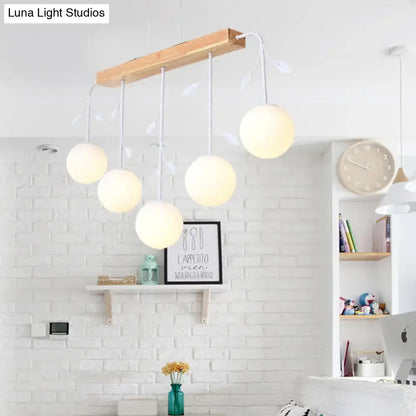 Modern DecorBites™ Nordic bubble shade island wooden hanging lamp with five warm glass bulbs and leaf accents for restaurants
