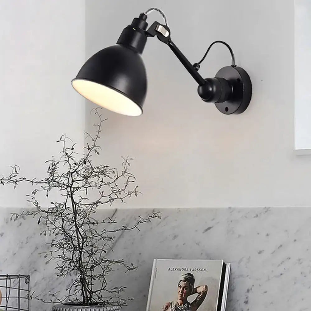 Minimalist black industrial-style wall mounted lamp with articulated arm and matte finish for living room use