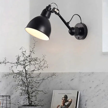 Minimalist black industrial-style wall mounted lamp with articulated arm and matte finish for living room use