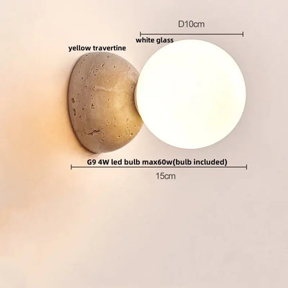 Modern wall light with textured yellow travertine base and smooth white glass globe for minimalist bedroom decorbites led wall