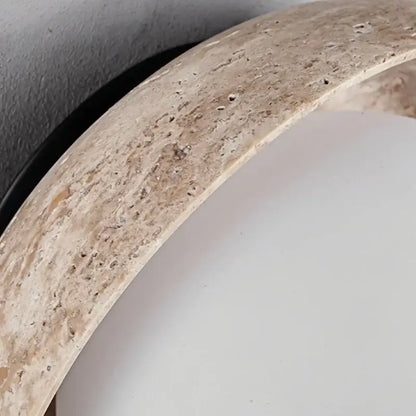 Beige stone mirror frame with textured natural finish complementing minimalist yellow travertine and decorbites led wall light