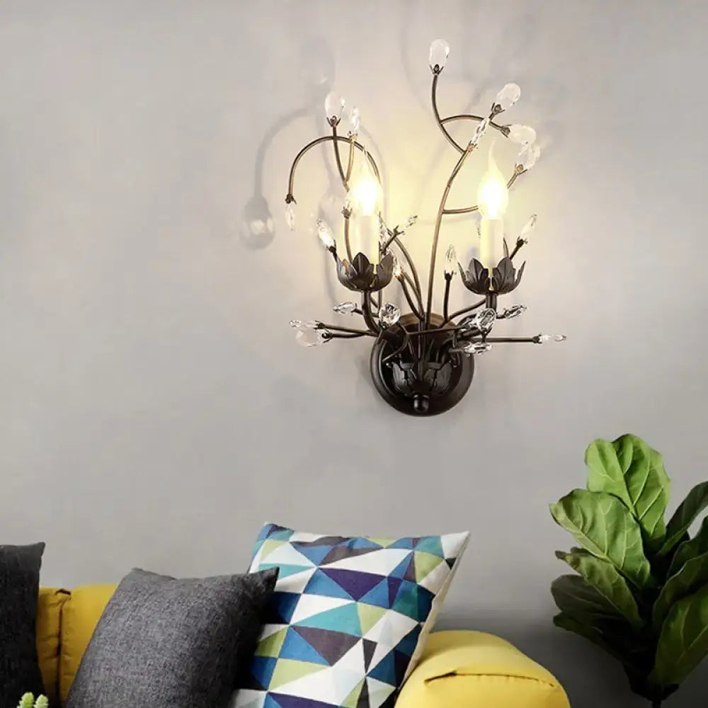 Dark bronze wrought iron sconce lamp with black crystal accents and candle-style bulbs for dining room wall light
