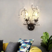 Dark bronze wrought iron sconce lamp with black crystal accents and candle-style bulbs for dining room wall light