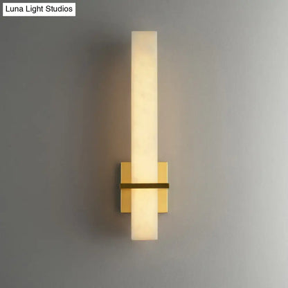 Modern minimalist wall sconce with frosted glass cylinder and brushed gold metal base for 110v-120v minimalistic marble wall use
