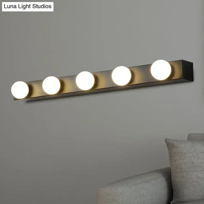 Minimalistic white vanity lighting fixture with four warm white open bulb lights in a sleek black metal bar