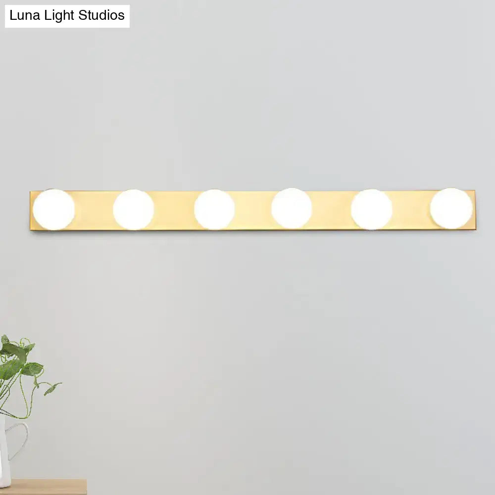 Gold-finished minimalistic vanity lighting fixture with five open bulb circular lights for bathroom use
