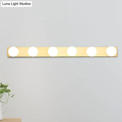 Gold-finished minimalistic vanity lighting fixture with five open bulb circular lights for bathroom use