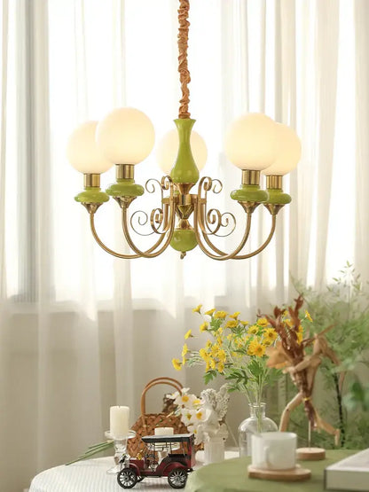 Vintage-style mint and gold cream style led chandelier with green ceramic body and frosted glass globes for dining room decorbites cream style