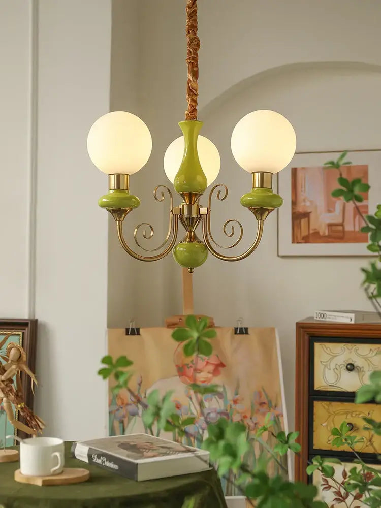 Mint and gold cream style led chandelier with three white globe bulbs olive green ceramic bases and brass arms for decorbites cream style