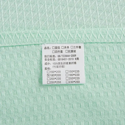 Mint green bamboo fiber cooling summer blanket with waffle texture and 100 percent regenerated cellulose fiber label by decorbites