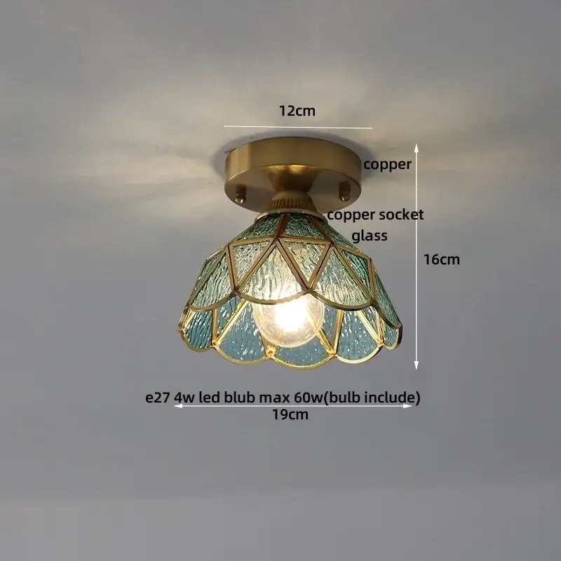 Vintage-style ceiling light with copper base and teal stained glass shade featuring geometric blue flower glass patterns