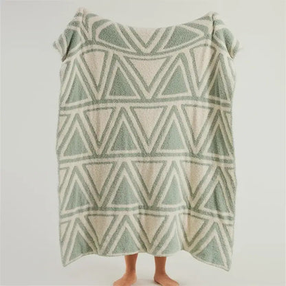 Soft plush mint green and cream knitted jacquard blanket with geometric interlocking triangles by decorbites