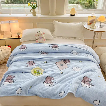 Light blue plush blanket with cartoon elephants on clouds complementing decorbites dinosaur patterns snowflake velvet design