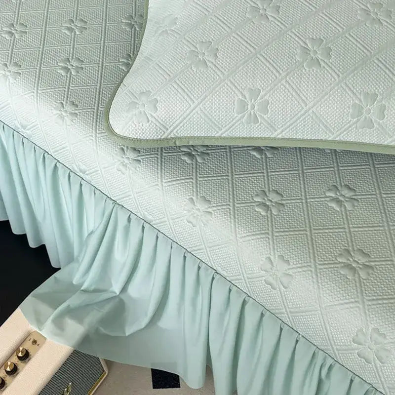 Light blue ruffled bed skirt with quilted floral and grid pattern in mint green floral quilted bed skirt set
