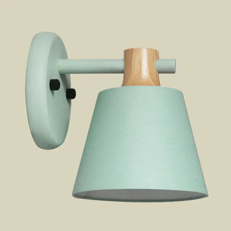 Pastel green matte bucket wall lamp with natural wood accent and minimalist nordic design for bedroom use
