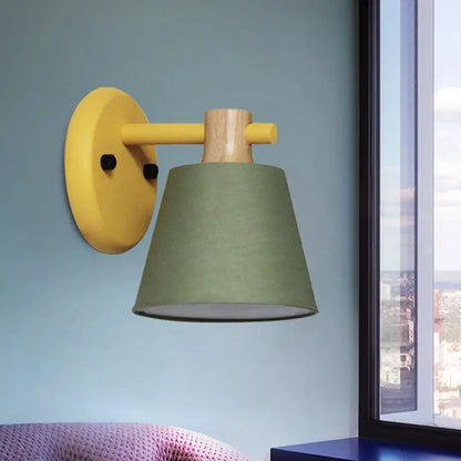 Yellow and wood-finished bucket wall lamp with olive green fabric shade and wood accent for bedroom use