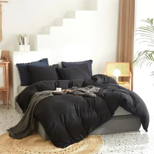 Black plush duvet cover set with navy blue pom-pom trim pillows complementing mint green quilted cover set design