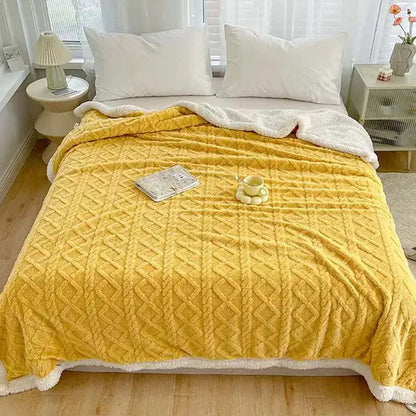 A cozy mustard-yellow decorbites coral fleece blanket with textured diamond-knit pattern and soft white fleece lining