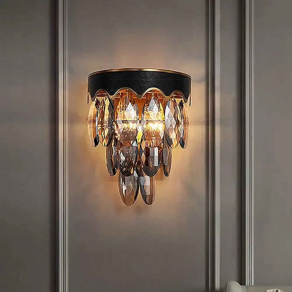 A modern 3-tier black and gold crystal wall lamp with amber glass crystals for elegant wall mount lighting