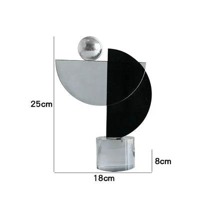 Modern abstract geometric crystal ornaments ring featuring sleek black silver crescent and chrome sphere on acrylic base