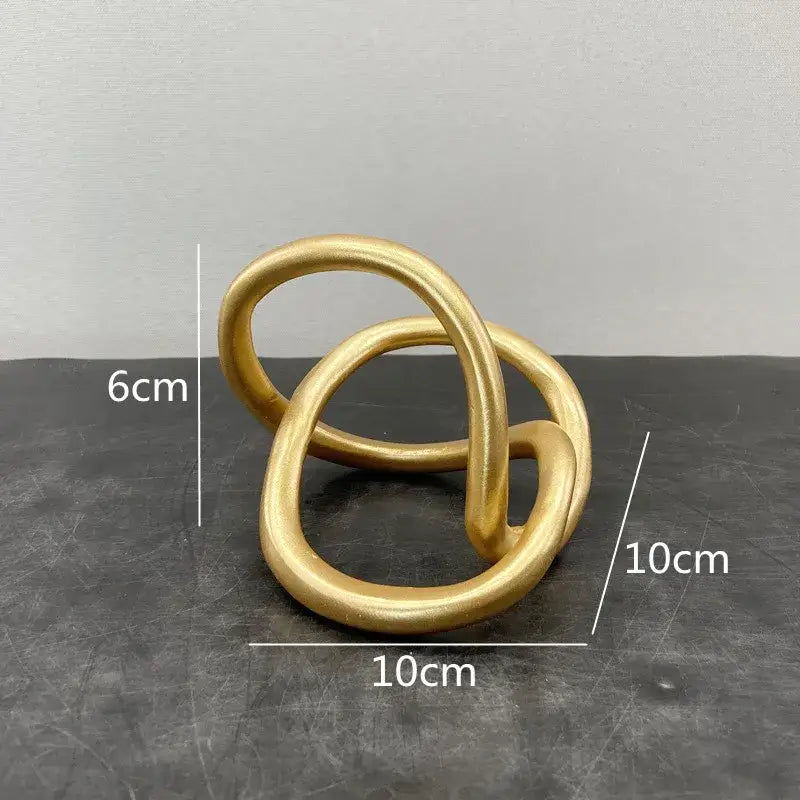 Modern abstract gold ring knot sculpture with smooth matte finish for living room art decor in gold color