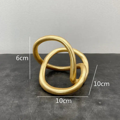 Modern abstract gold ring knot sculpture with smooth matte finish for living room art decor in gold color