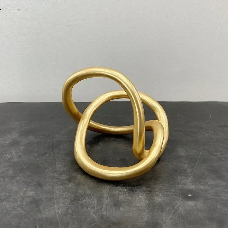 Modern abstract gold ring knot sculpture with smooth polished finish for living room art decor