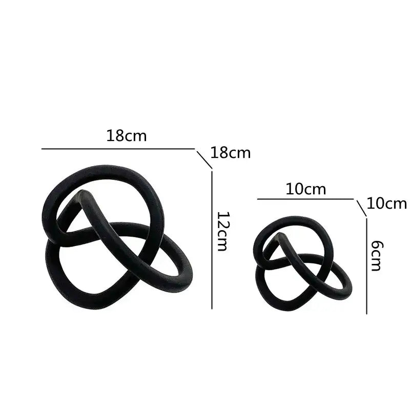 Black matte-finished sculptural knot decorative objects in two sizes for modern abstract gold ring knot living room decor