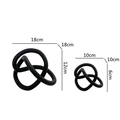 Black matte-finished sculptural knot decorative objects in two sizes for modern abstract gold ring knot living room decor