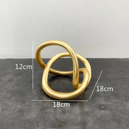 Modern abstract gold ring knot sculpture with smooth metallic finish for living room art decor